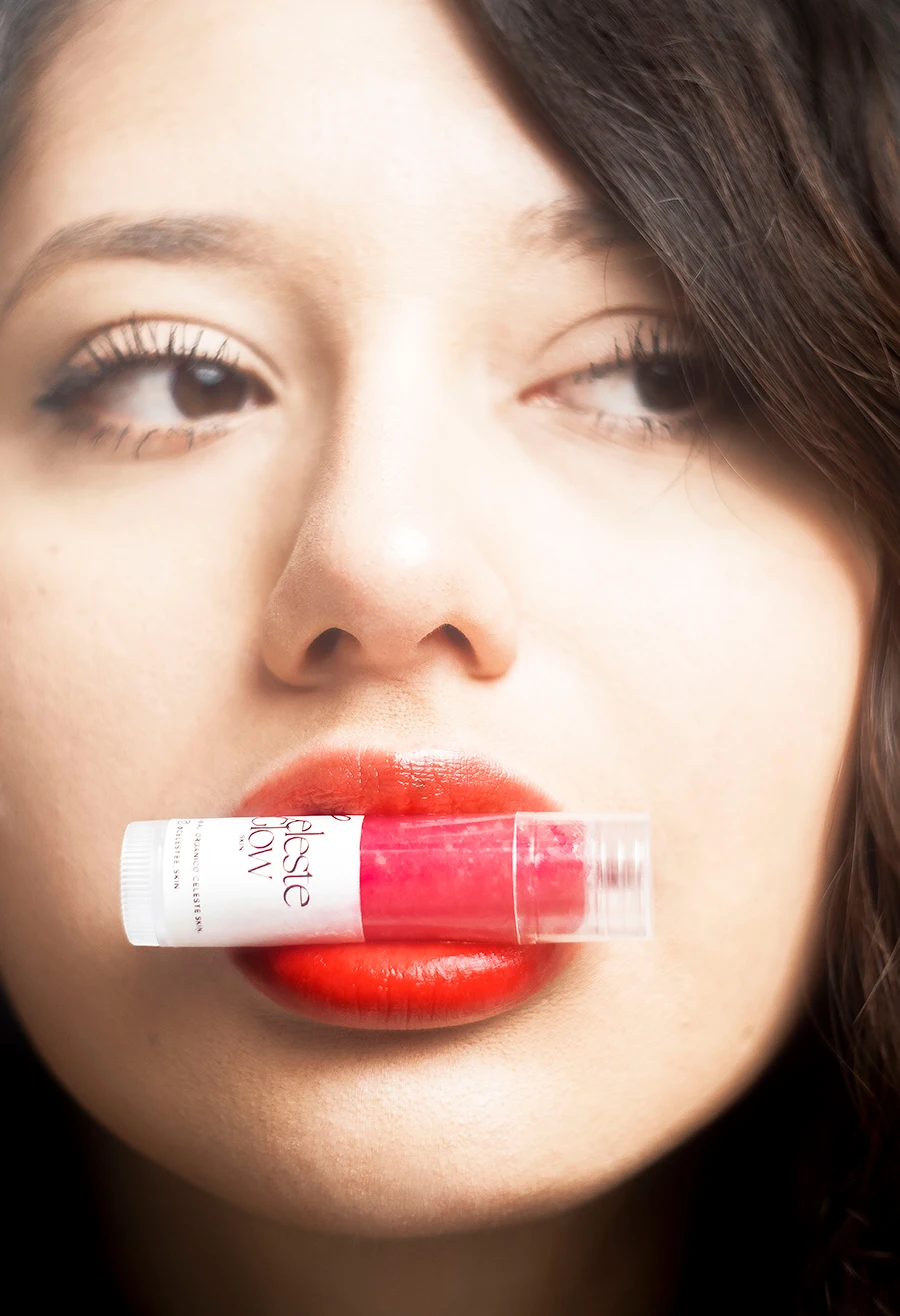 a woman with red lipstick in her mouth